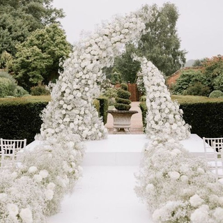 White Aisle Stage with Flower Arch